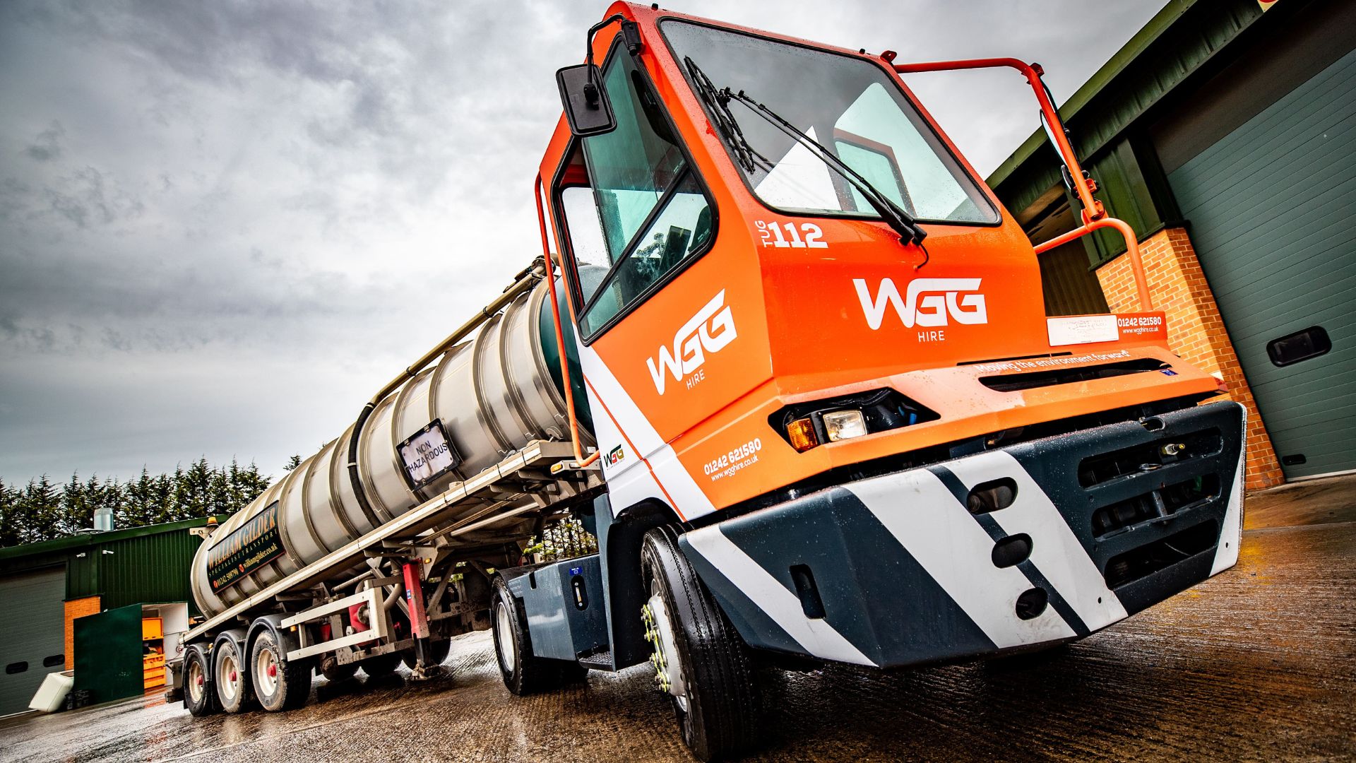 Shunting tug positioning a tanker trailer at an industrial loading facility