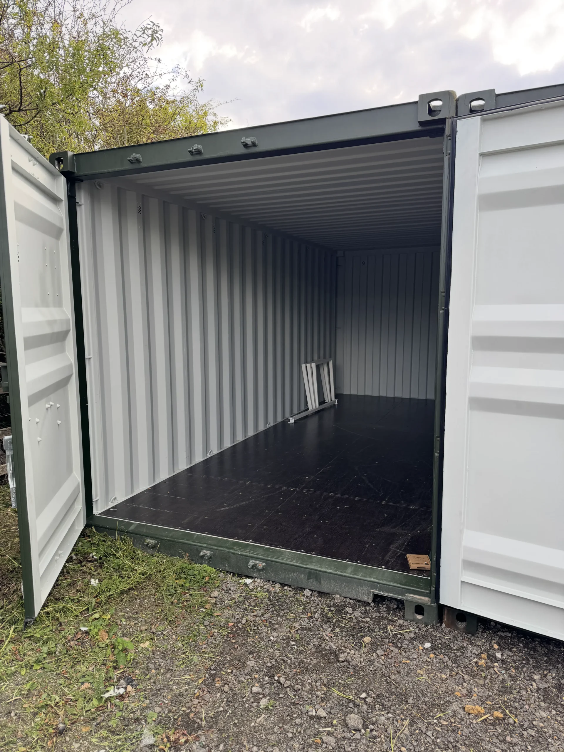 Looking out from inside a self storage container with business items outside