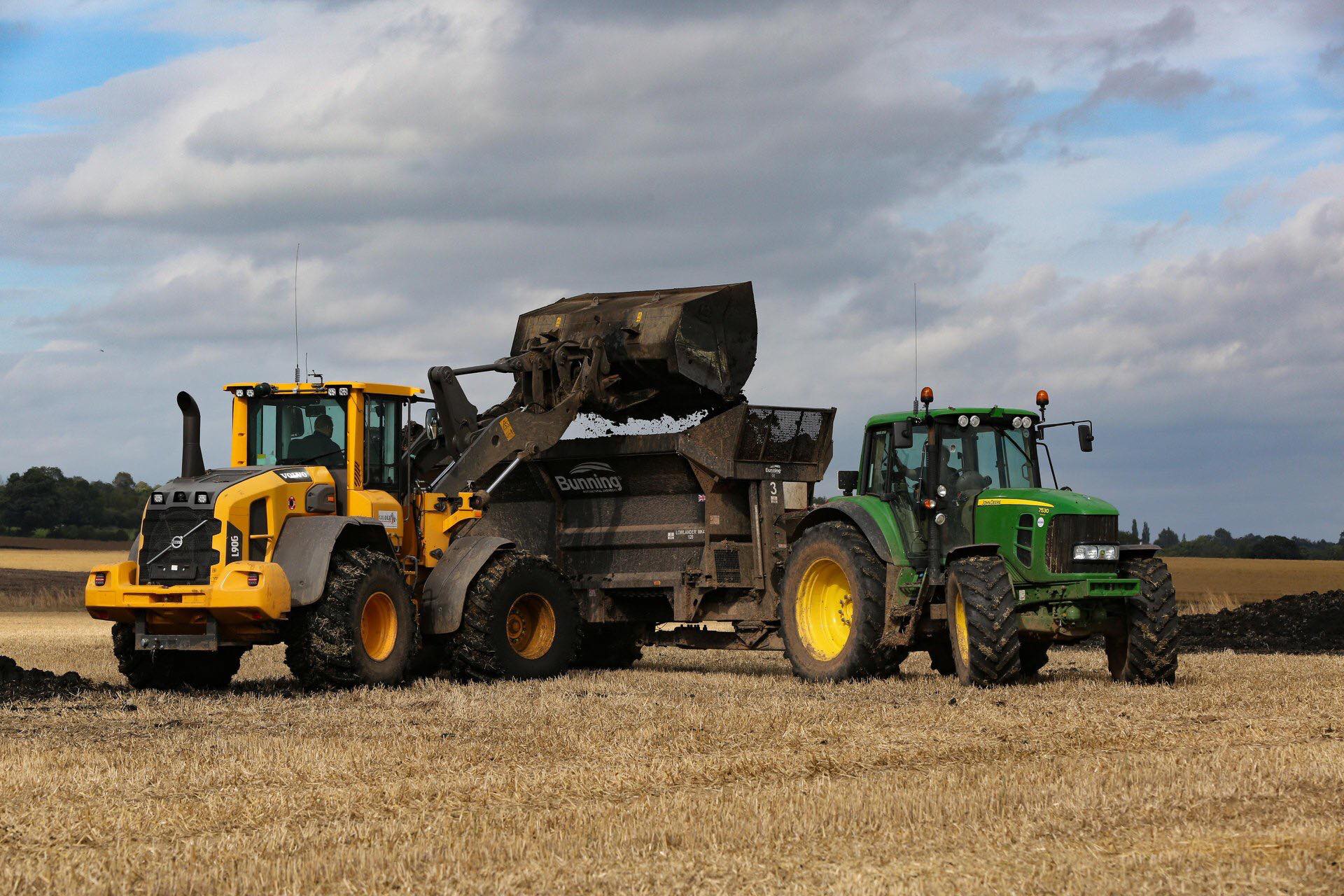 Soil being loaded into a tractor trailer in a field