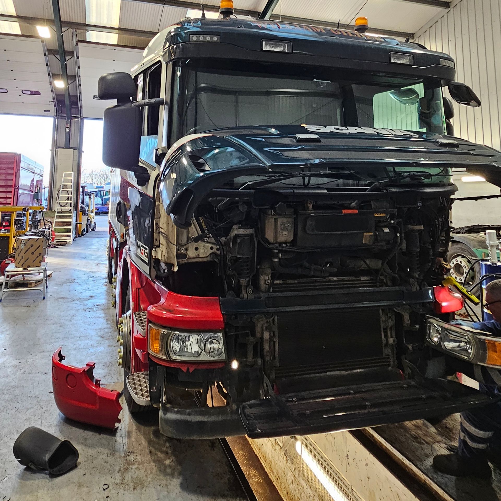 A lorry being repaired in a garage