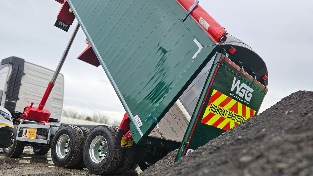 A lorry trailer tipping gravel in a quarry